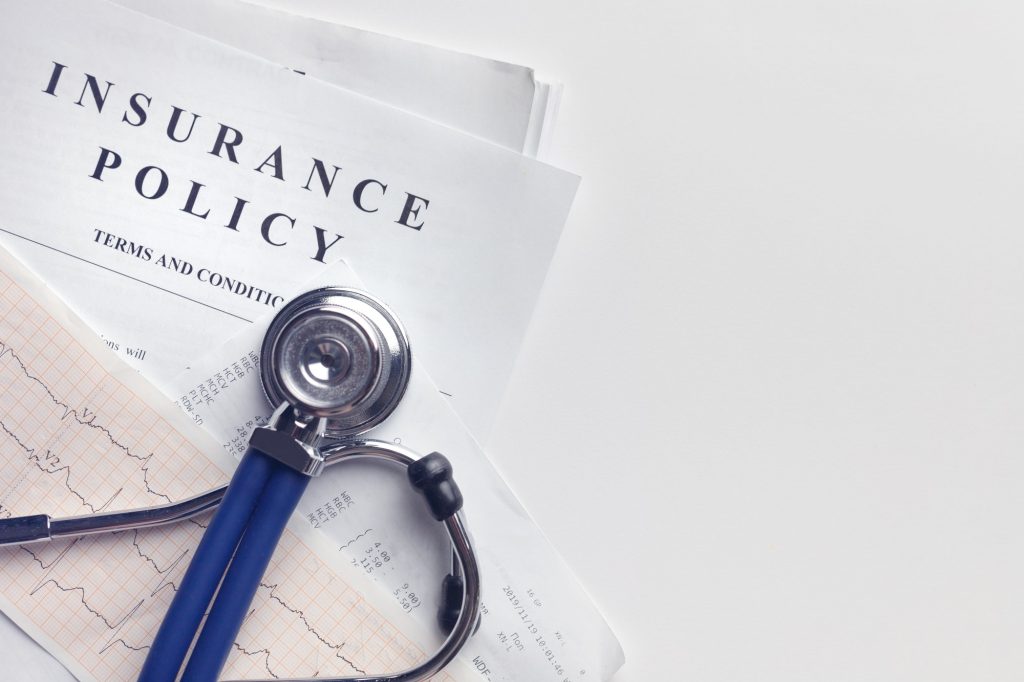 Health insurance. Health insurance form, medical stethoscope, cardiogram chart.